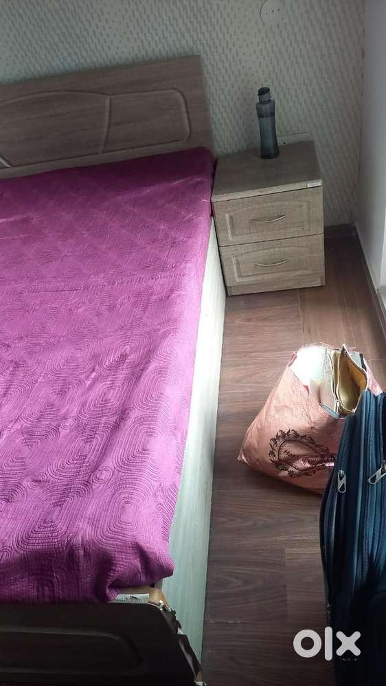 Double bed with mattress and a side table