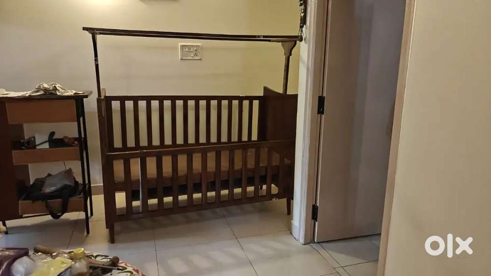 Teakwood baby cot with frames for mosquito net.