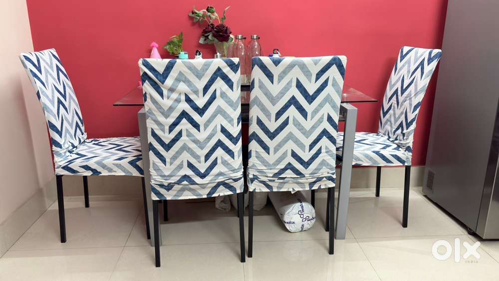 Four seater glass top dining table with four chairs