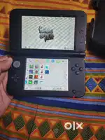 Nintendo 3ds ll with games and accessories and box.