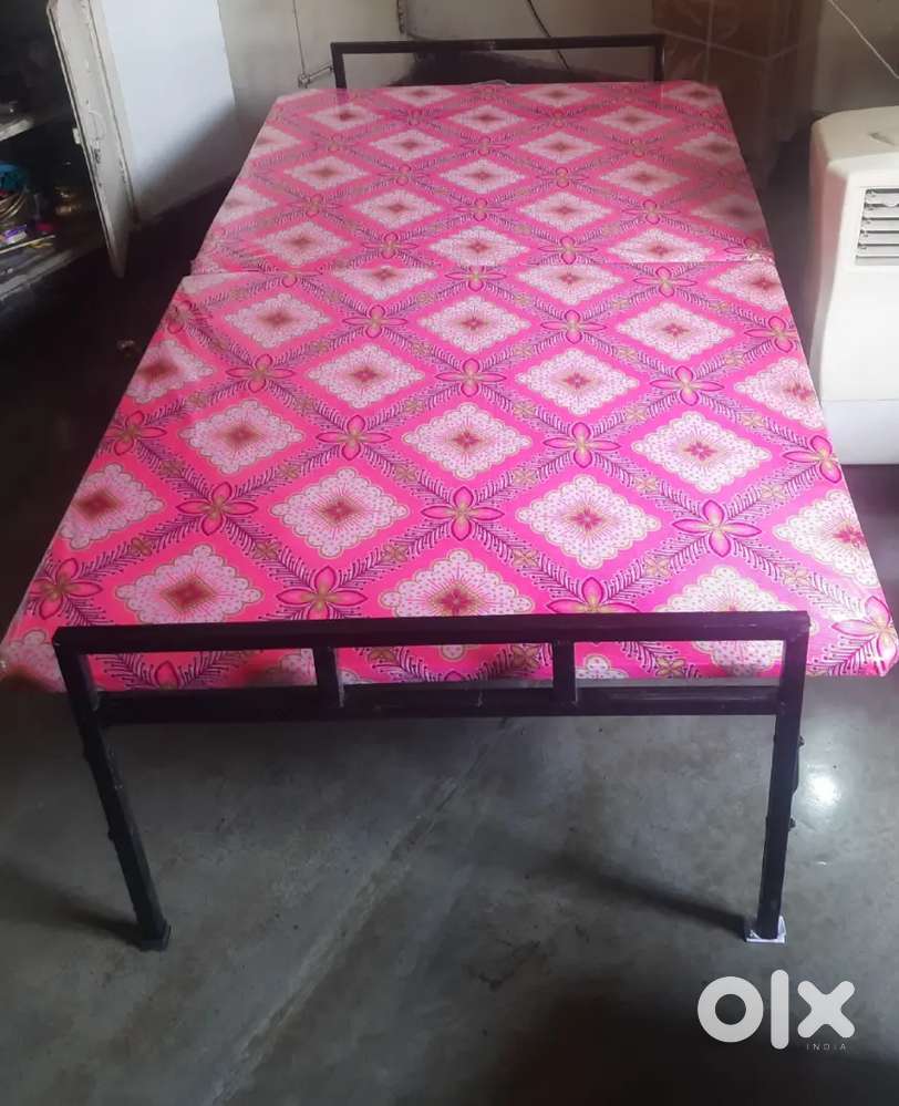 Folding Bed with attached bedding.