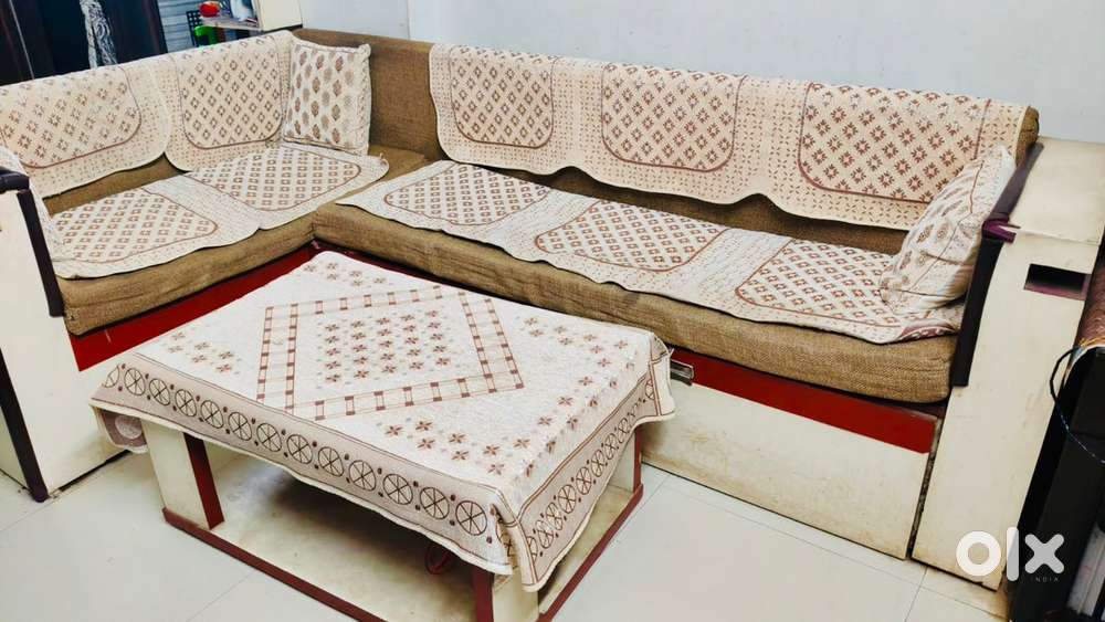 Wooden L-shaped sofa with gadda and centre table