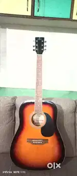 New acoustic guitar is available for sell with bag plectrums belt