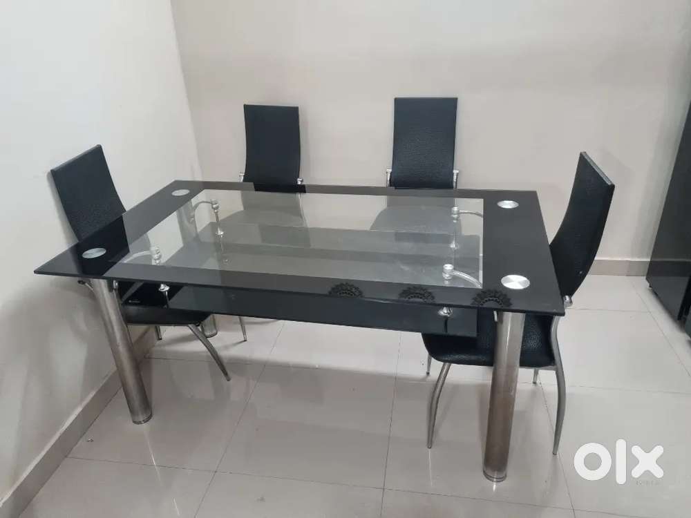 Modern 6-Seater Glass Dining Table with Black Leather Chairs of Godrej