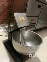 It automates the mixing and kneading process for various dough types.