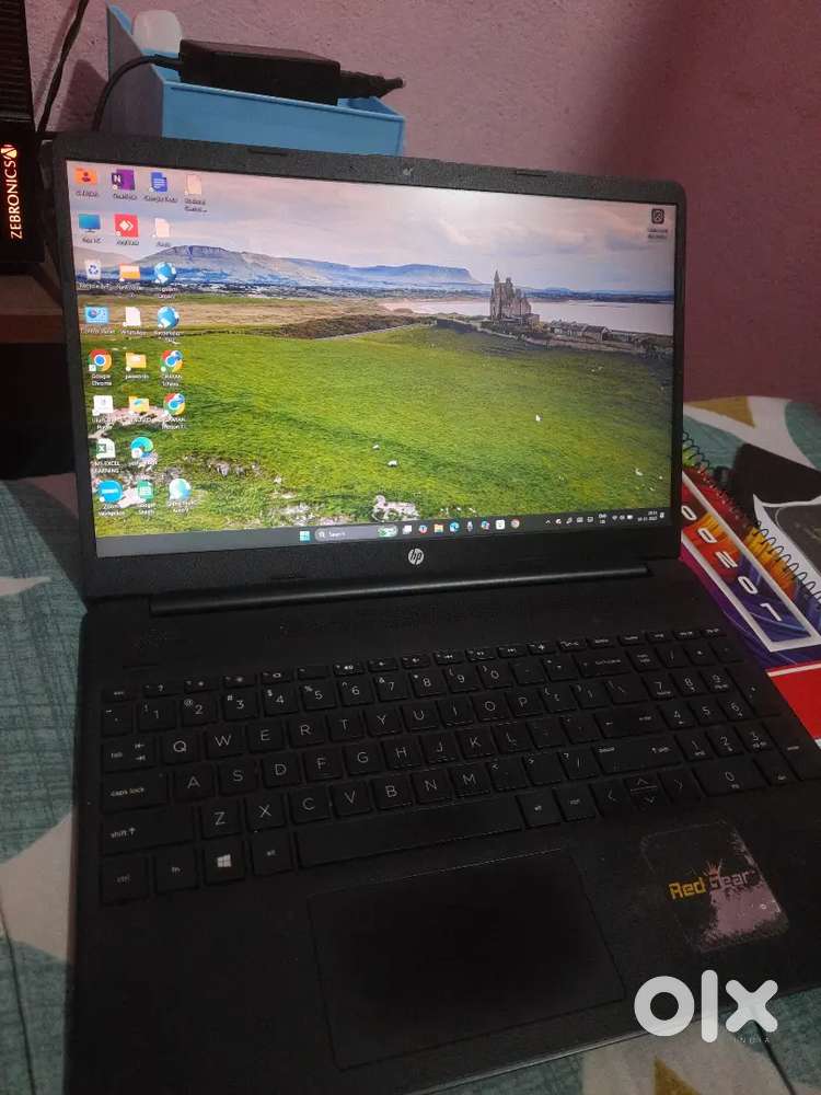 Laptop HP along with a writing pad