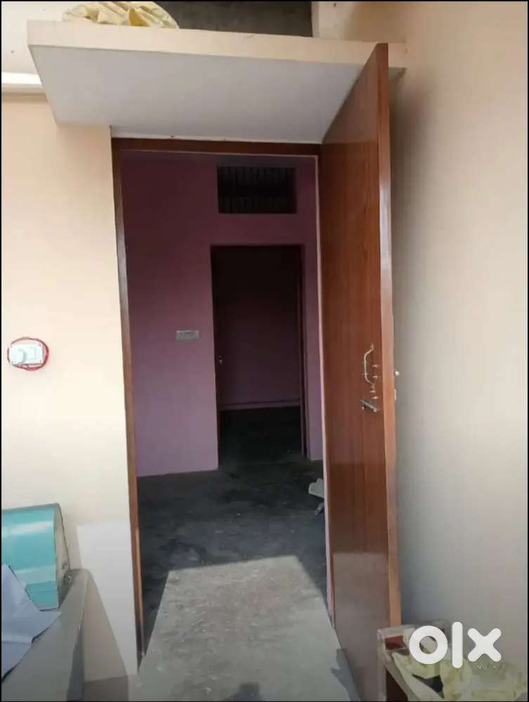 A room with a kitchen and a separate bathroom