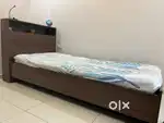 Single bed with headrest and over head shelf