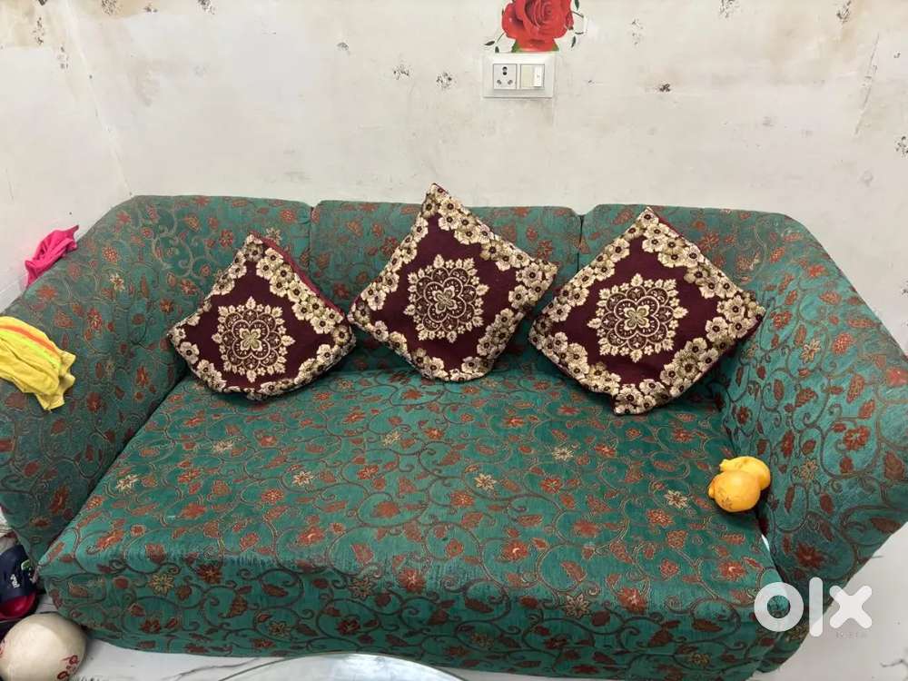A beautiful sofa green colour dard and comfortable seat ,