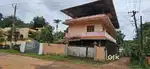 Pullad Ayirakavu road frontage 8 cent house with 2 shops for sale.
