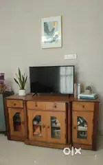 Tv cum showcase antique stand with unique crafted wooden work.