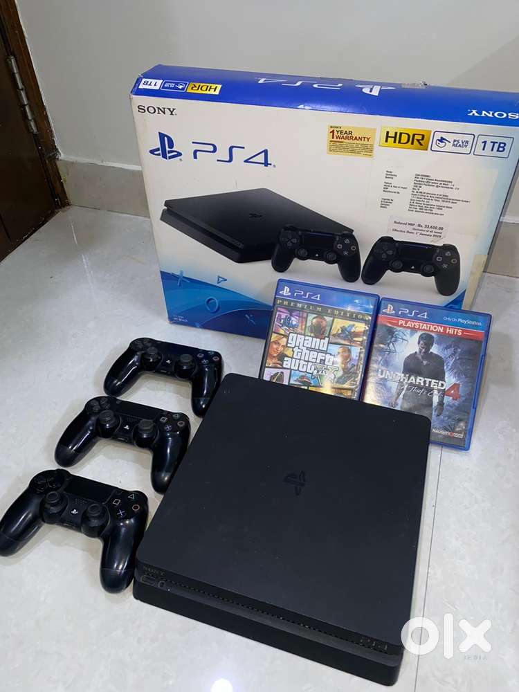 PS4 Slim 1 TB Mint Condition with 3 controllers 2 games With Box