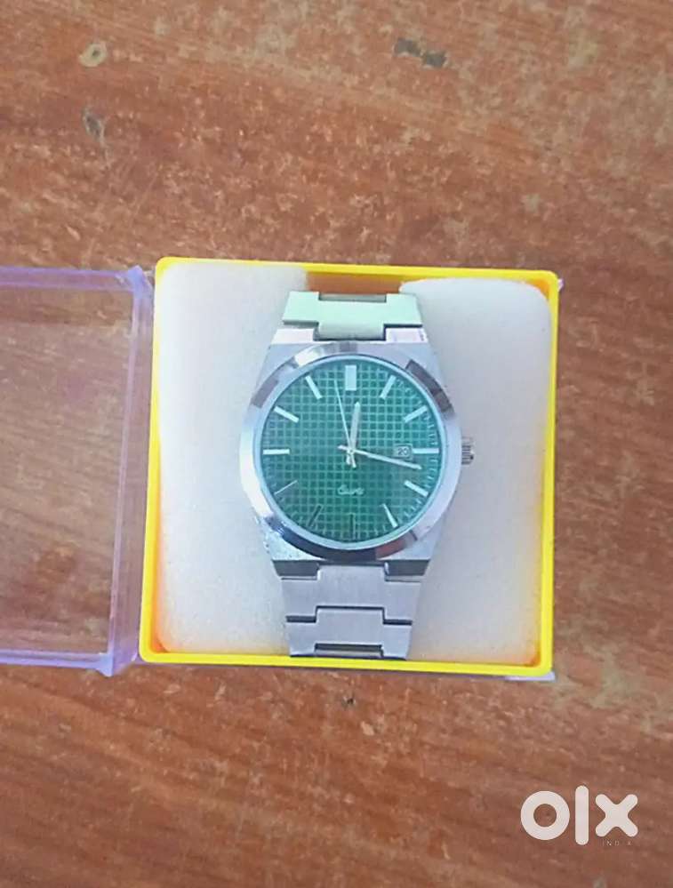 Emerald green dial raw metal watch