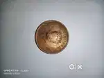 The coin in the image is a 1/4 Anna coin from British India,