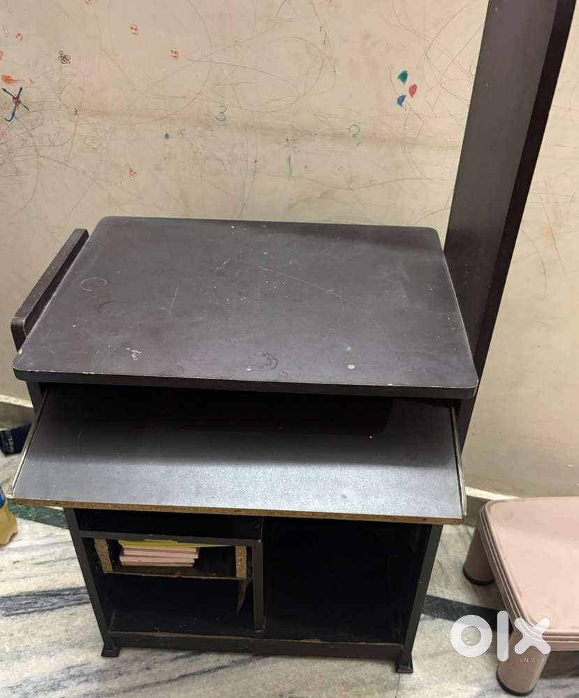 It is a brown computer desk