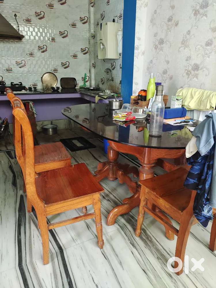 wooden dining table and four chairs