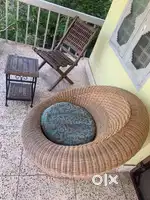 Garden furniture containing a wicker chair, a wooden chair & stool