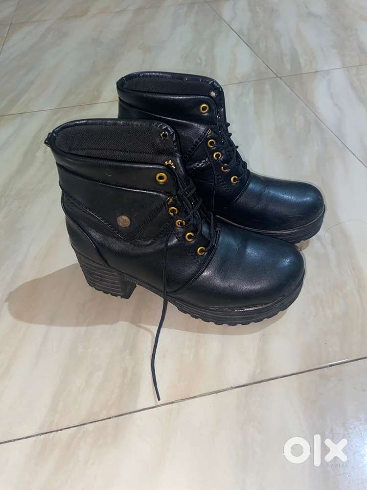 Strong lace-up boots with heel, durable, stylish, and comfortable fit.