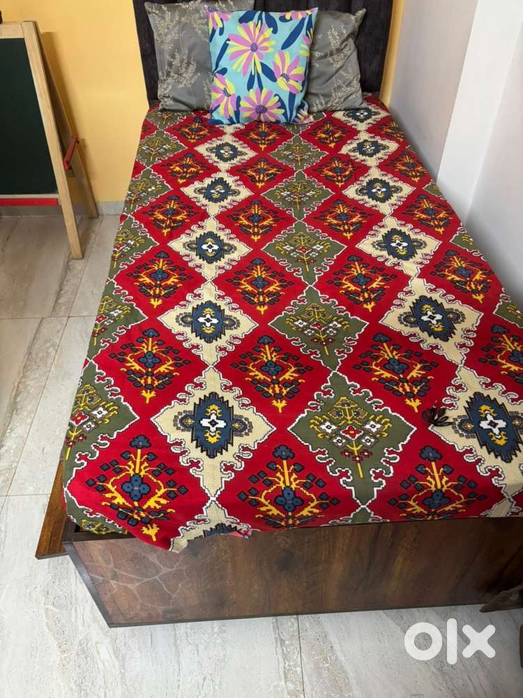 A single bed with mattress and a head board