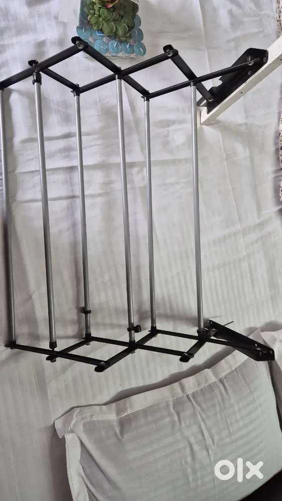 foldable wall-mounted clothes drying rack.