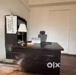 Office table with set up of  printer and book shelf