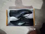 Two formal boots one pair black shiny and one pair brown boots