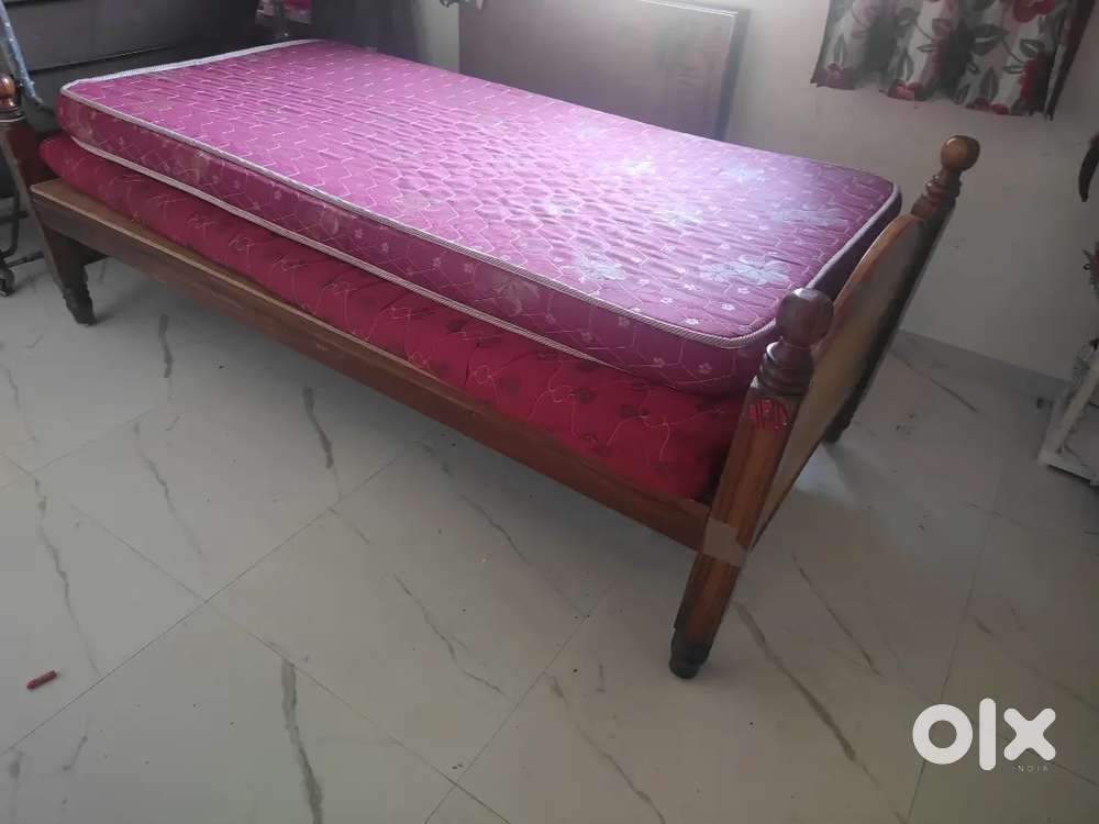 Wooden cot with beds
