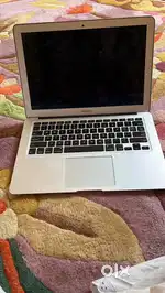 An apple laptop in good condition with a silver body very nice piece