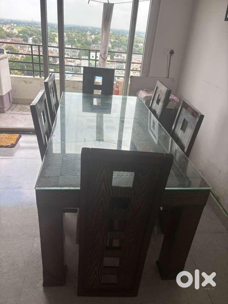 Wooden Dinning table with top glass and set of 6 chairs .