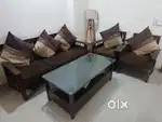 Wooden Sofa with cushion cover and  center table in Good condition