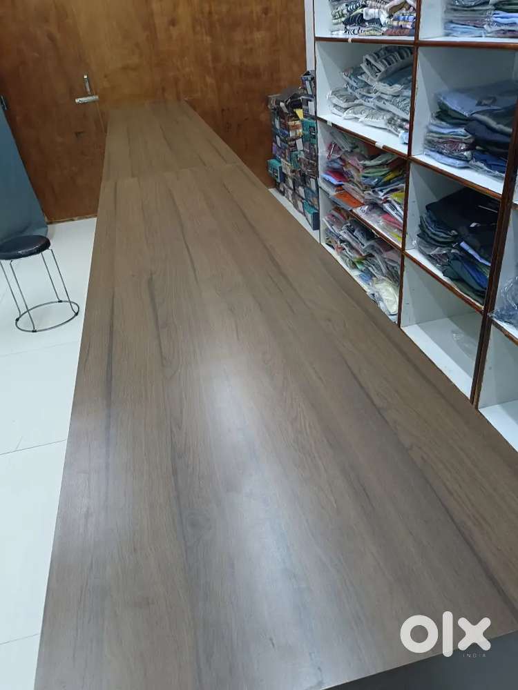 Clothing store wooden and glass tables ,2 teble is 8 ft ,1 tebla is 7f