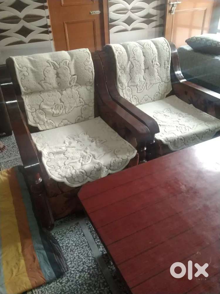 5 seater wooden sofa with wooden table.