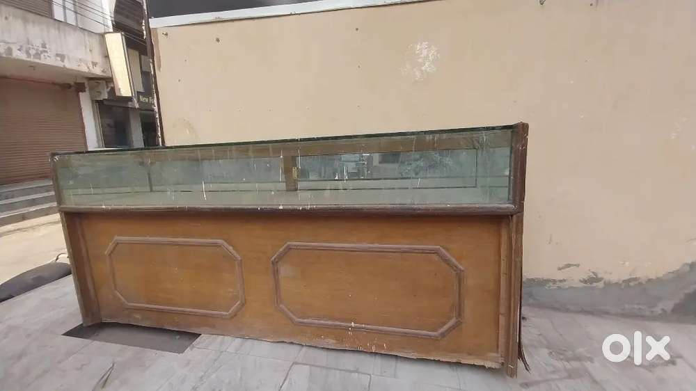 Wooden display counter with glass top