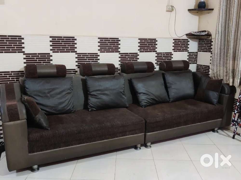Chocolate Coloured Sofa with 4 Large and 2 small pillow .