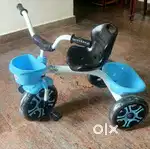 Tricycle for kids with dual storage baskets available for sale.