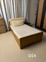 Single bed with mattress and side table