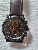 Fine wrist watch in good condition. Black dial and brown belt .