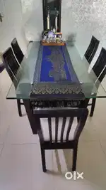 Six seater glass top dining table