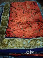 Orange floral net saree with navy blue blouse