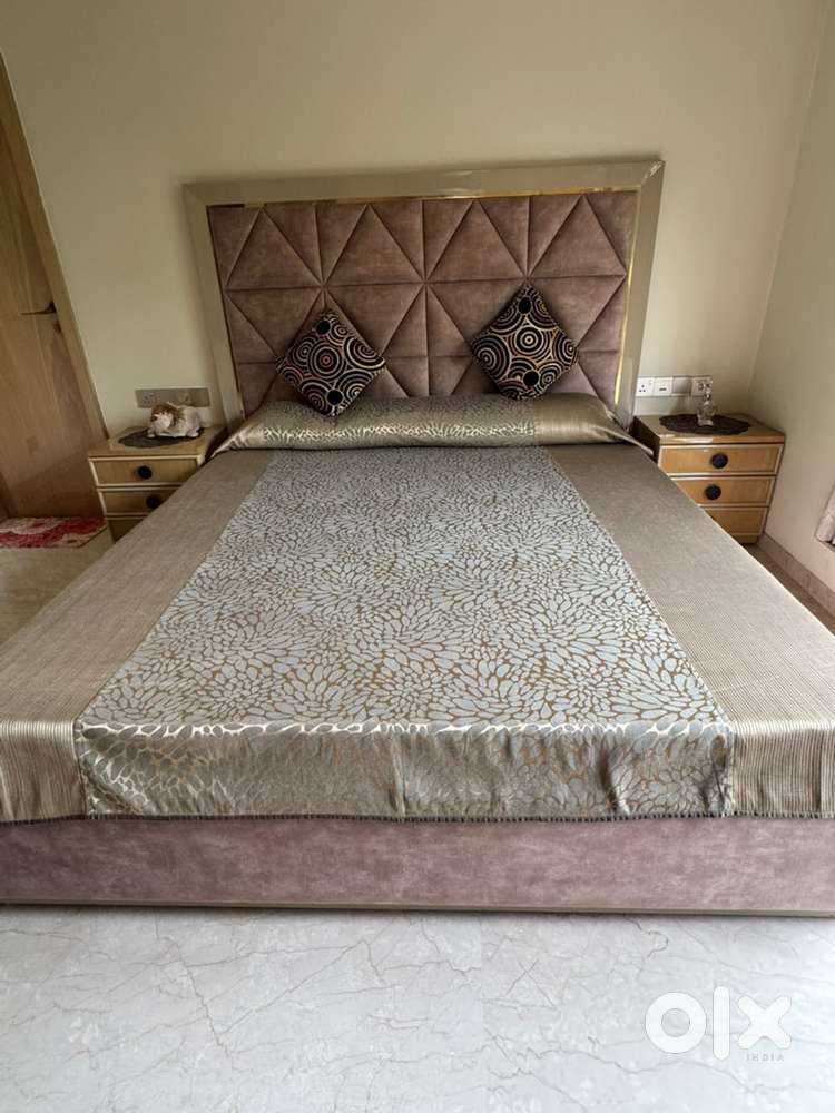 Full polycoat with fabric king size bed. 2 side tables with drawers.