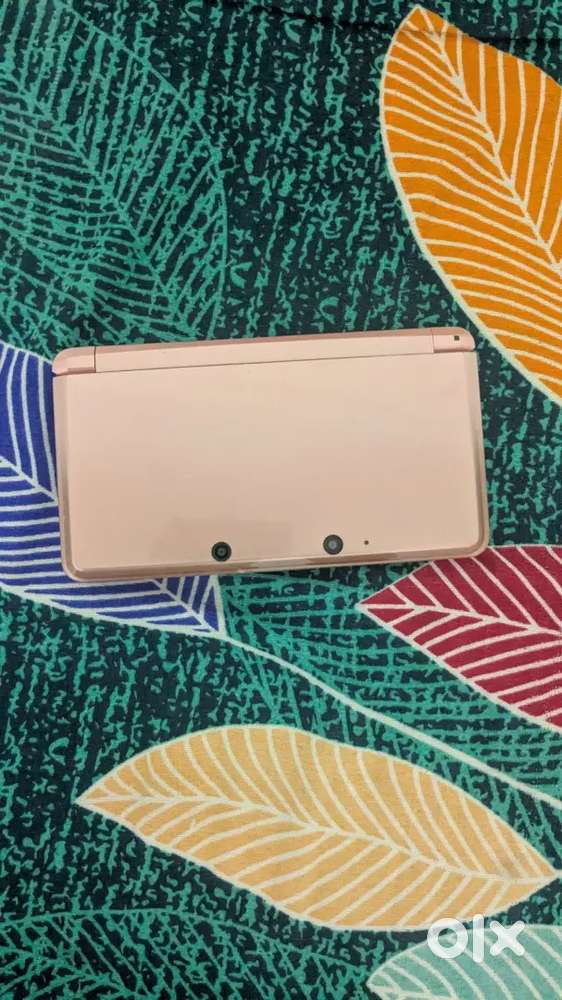 Nintendo 3ds with a game of 3ds and a Cartridge of pokemon red