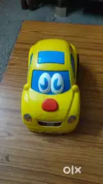 Yellow Toy Car with Cartoon Eyes