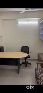 Fully furnished office with chair and table set with exhaust fan