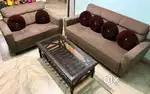 Sofa with water-resistant fabric and a glass-top wooden table