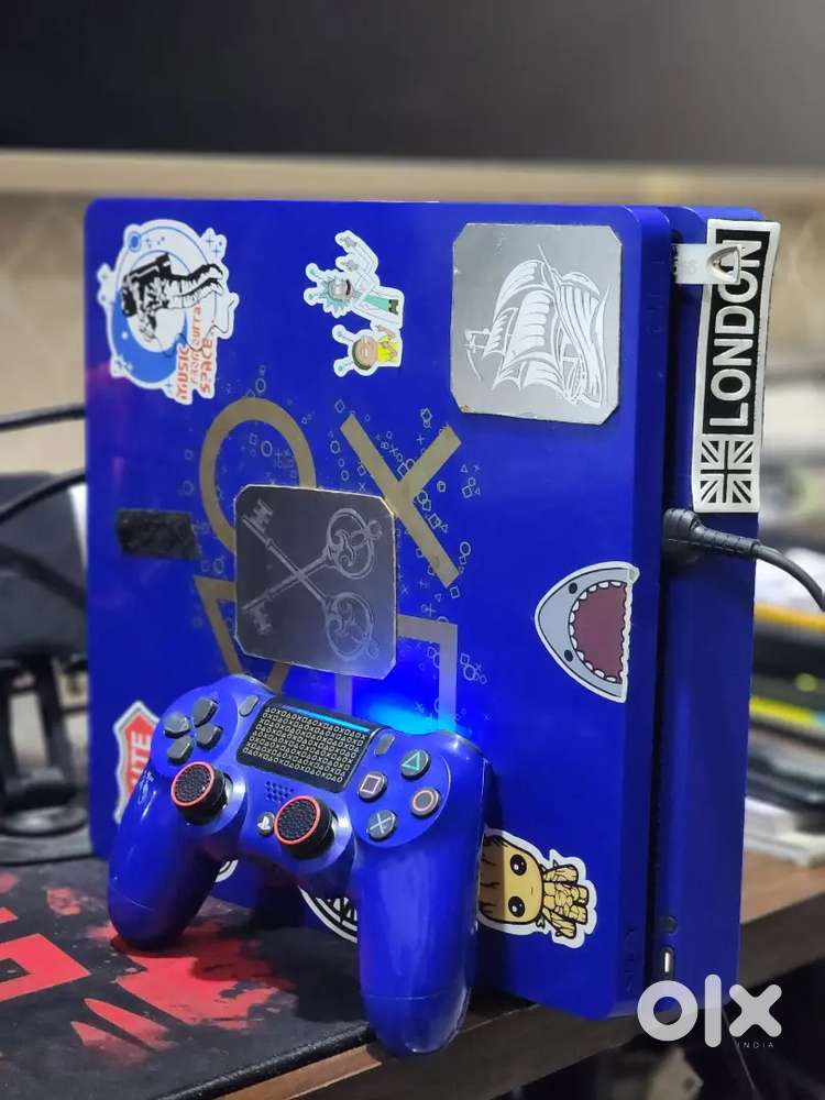 PS4 Slim 1TB (Days of Play) with games for sale.