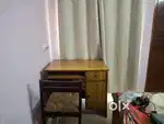 Wooden study table and chair available for sale.