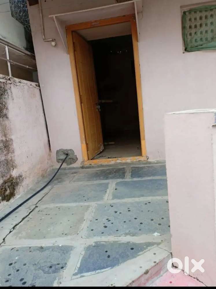 Single room with attached bathroom and wash area