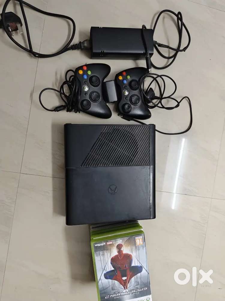 Xbox 360 console with 3 controllers and 6 games