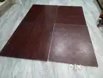 Double cot bed with brown plywood surface