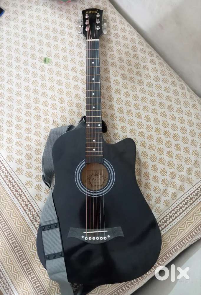 It's a acoustic guitar of black colour and Assesories will be provided